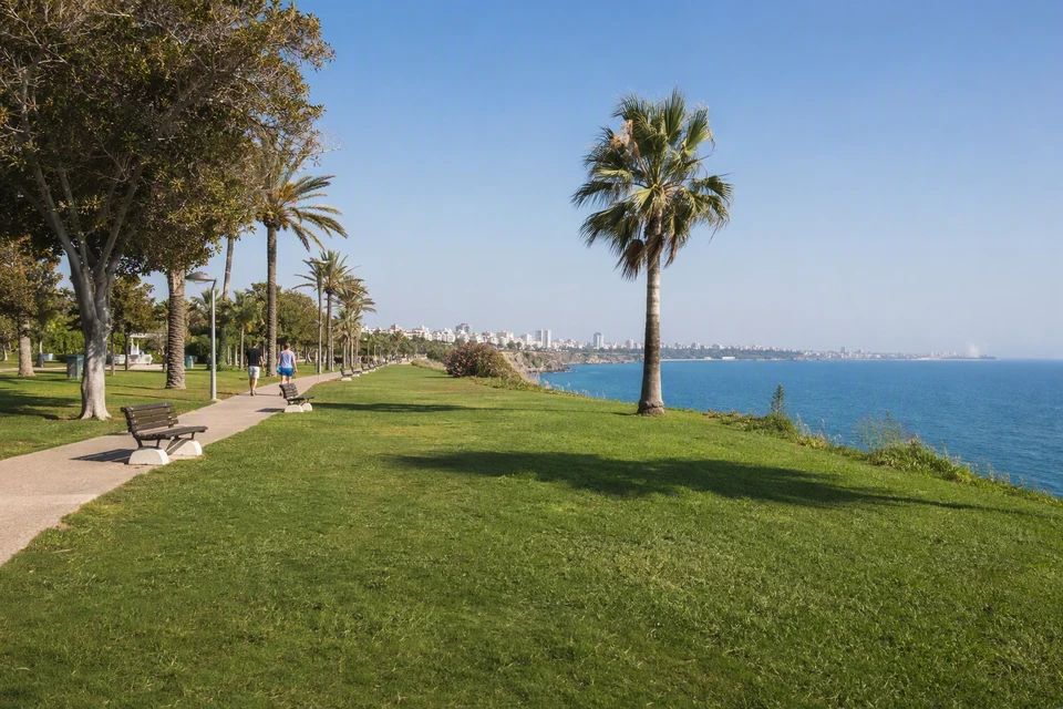 Green coastal park and promenade beside Lower Duden with the Mediterranean beyond, AI recreation